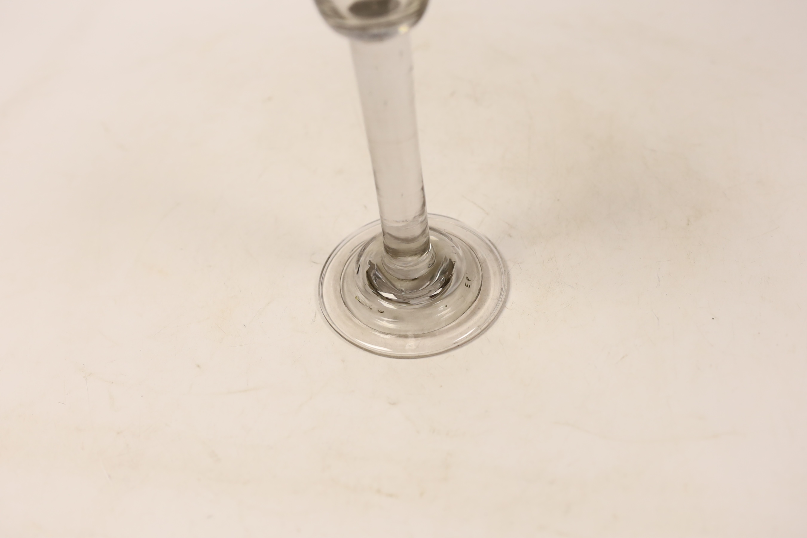 A George I or George II plain stem cordial glass, c.1720-30, with folded and domed foot and wheel engraved rim decorated with grape vines, 17.5cm